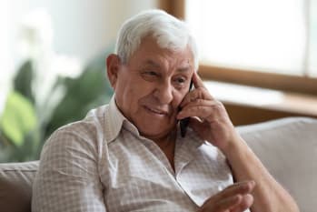 Smiling older man talking on mobile phone