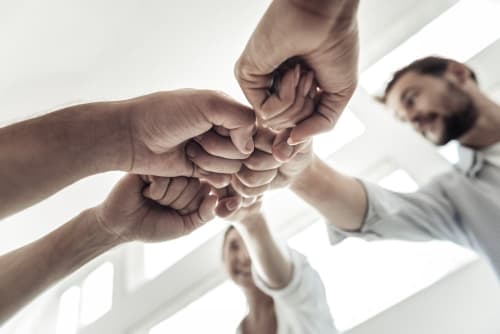 Group of people punching hands