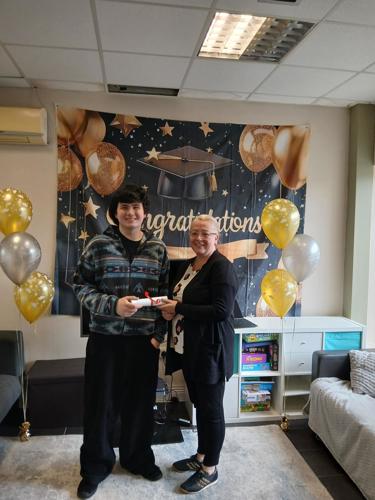 Extern youth worker congratulating a young person at an iScoil QQI graduation celebration